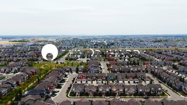 Aerial view of a suburban neighborhood showing rows of houses, streets, and green spaces in a well-planned community. Perfect for highlighting residential real estate, urban development, and community living.