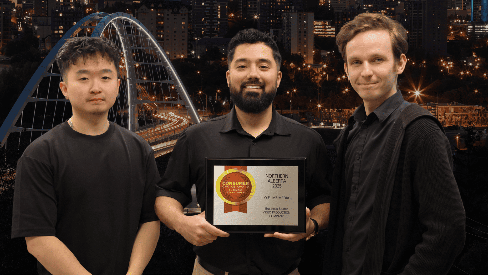 Award-winning video production team holding a Northern Alberta 2025 Consumer Choice Award, celebrating success in the media and business sector with cityscape and bridge background.