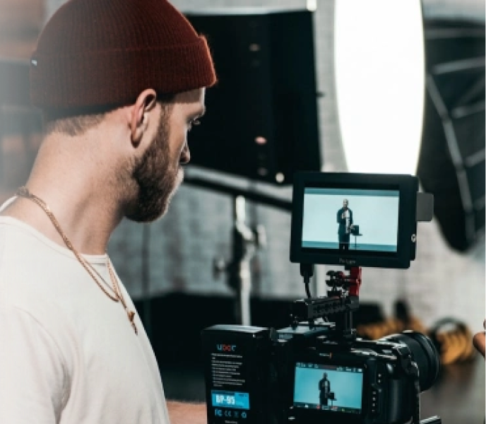 Filmmaker operating professional camera equipment for testimonial video production at Q Filmz Media.
