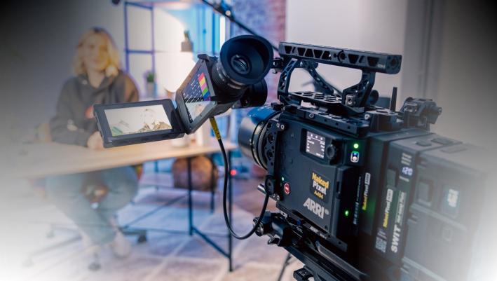 High-quality professional video camera setup for filming interviews or documentaries in a studio environment.