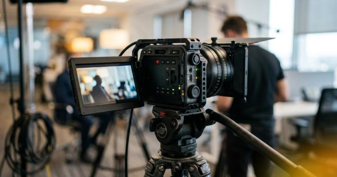 High-quality professional video camera on tripod in a modern studio environment, ready for filming testimonial videos at Q Filmz.