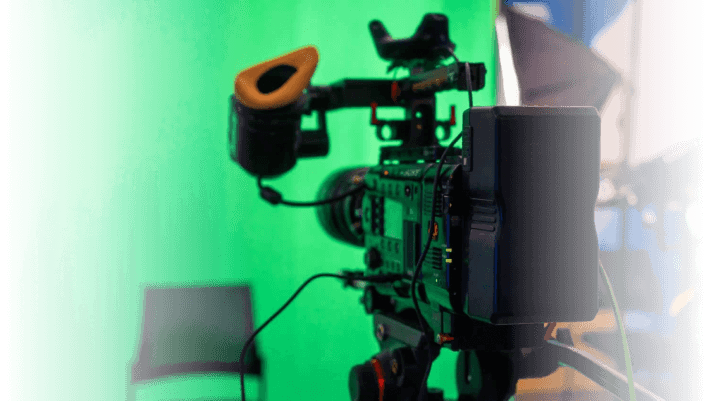 High-quality professional video camera on a tripod with a green screen background, used for advertising and media production in Edmonton.