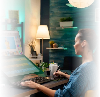 Female video editor working on a computer with video editing software in a modern, well-lit studio environment.